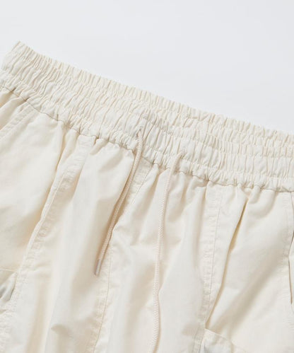 寬鬆彎刀版型 口袋抽繩設計 休閒工裝褲